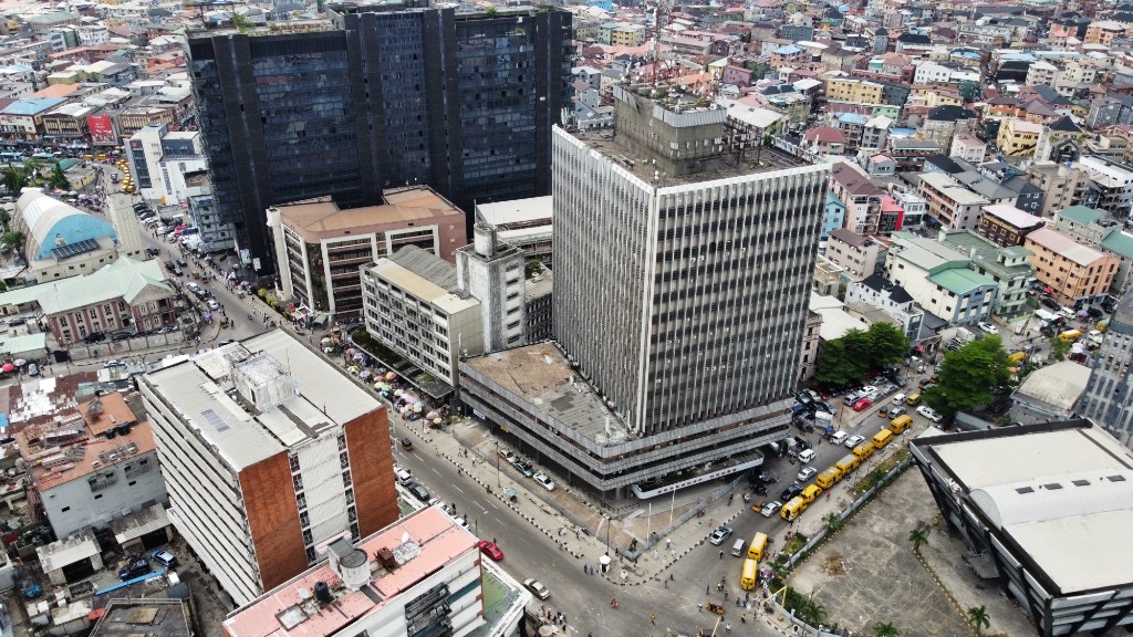 Aerial view of a busy urban city center with skyscrapers, traffic, and pedestrians